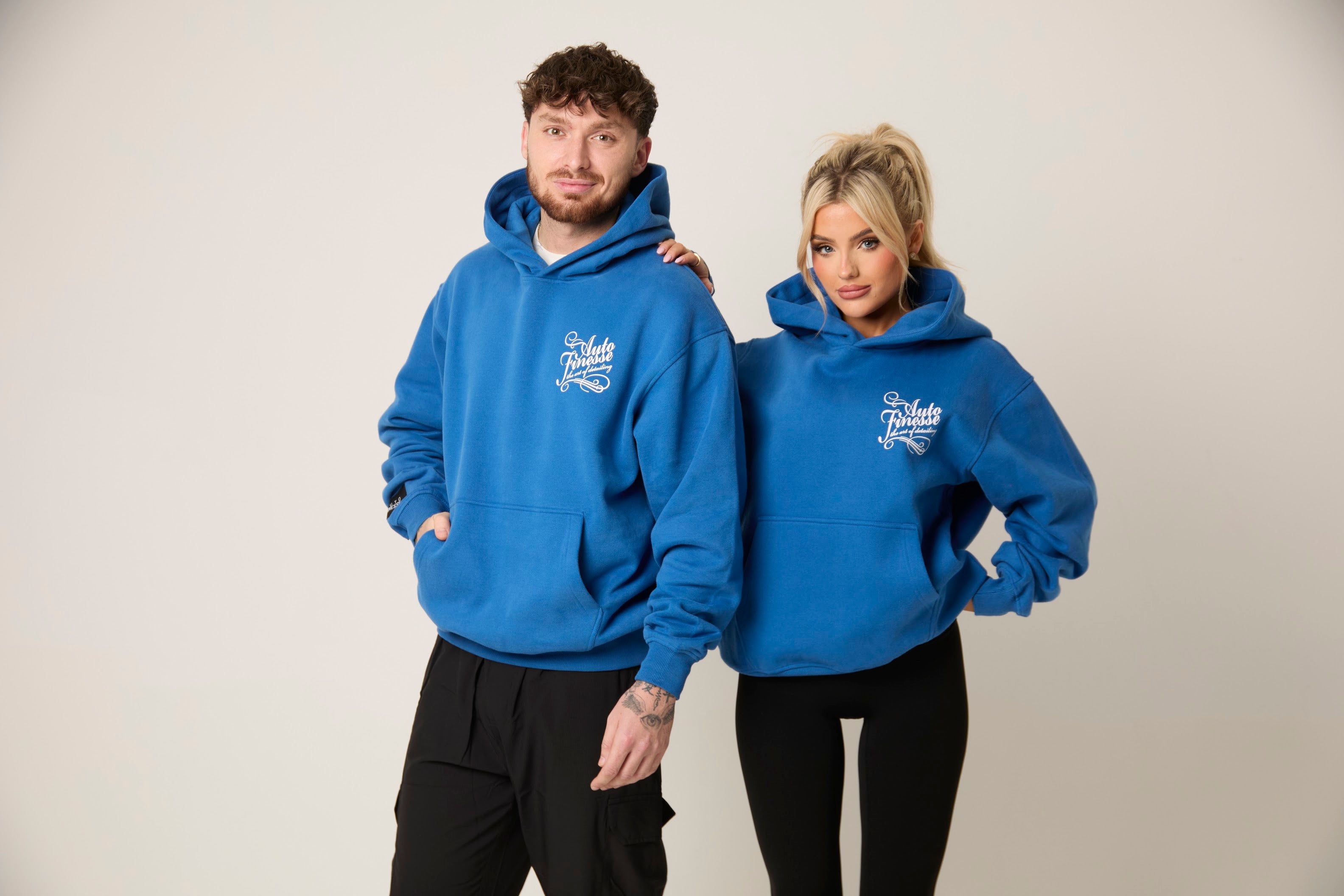 Man & Woman wearing blue Auto Finesse hoodies