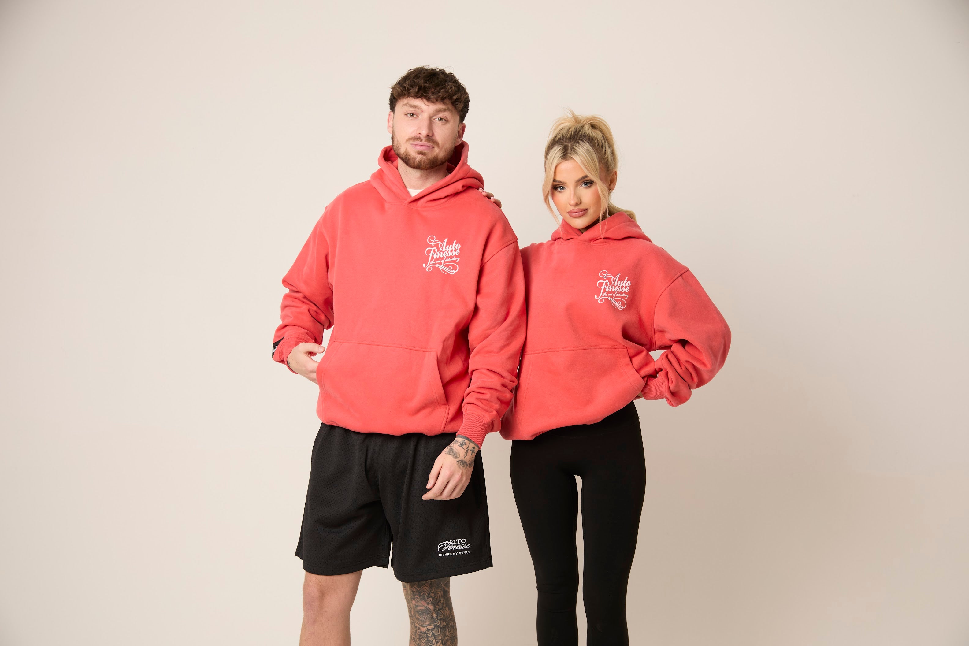 Man & Woman wearing Auto Finesse hoodies in red