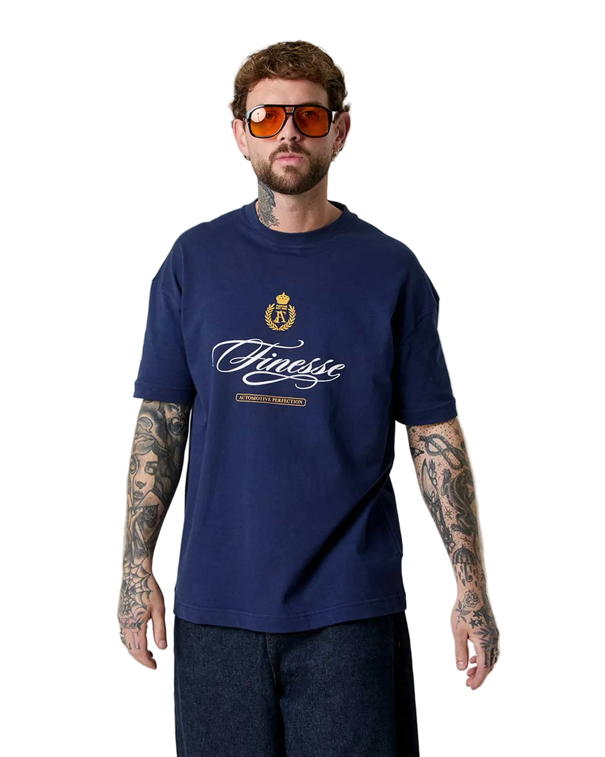 Man wearing a navy blue t-shirt with a logo and text, standing against a plain background