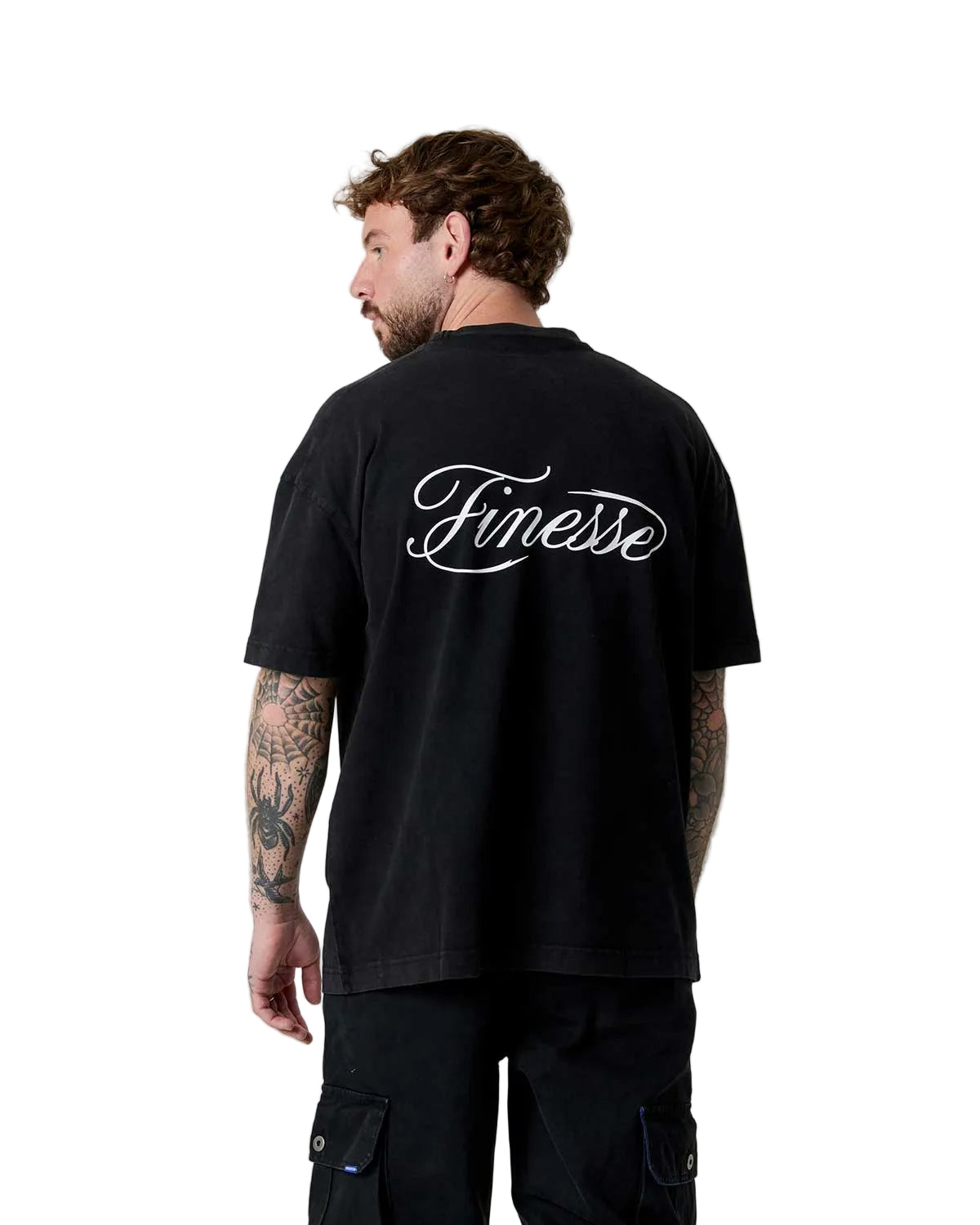Man wearing a black t-shirt with 'Finesse' logo on the back, standing against a plain background