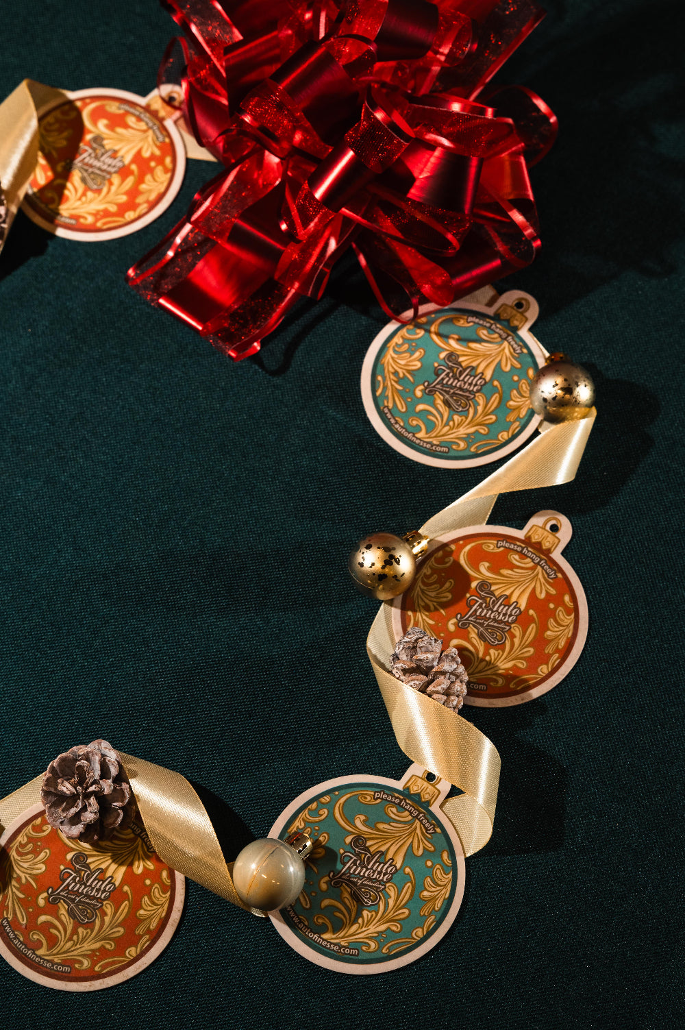 Christmas ornament-shaped air fresheners with ribbons and pinecones