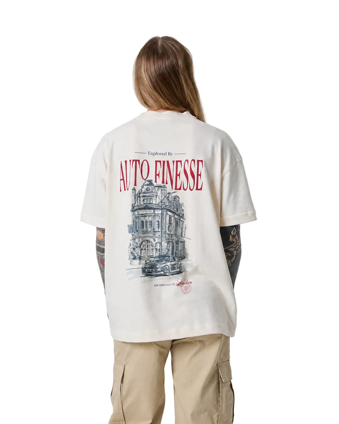 Person wearing a cream t-shirt with a graphic design and text on the back, standing against a plain background.