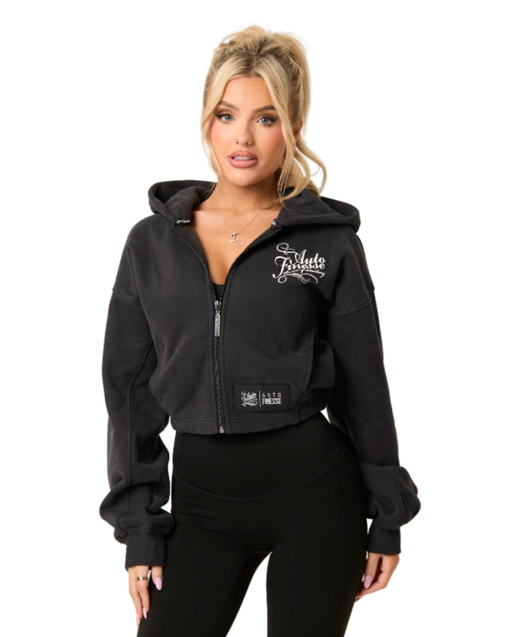 Woman wearing a black hoodie with branding on a white background