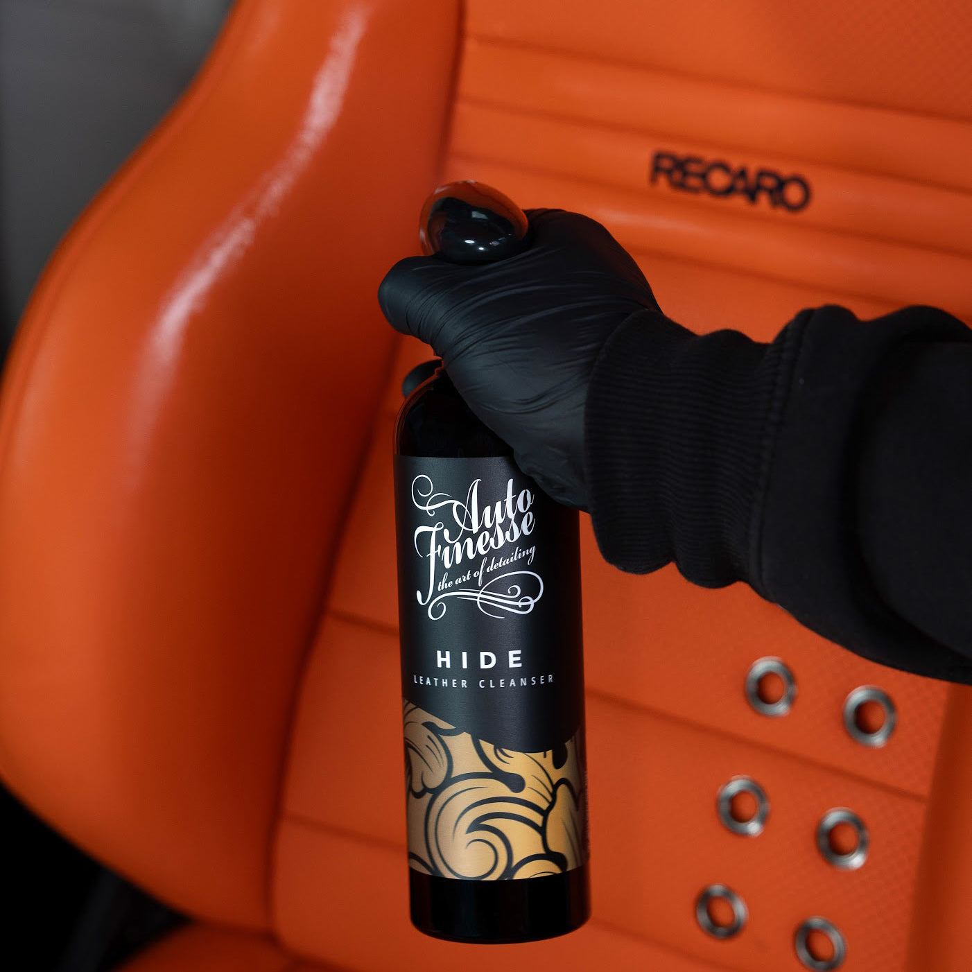 Spraying Auto Finesse Hide leather cleanser on a Recaro seat_ Leather Cleaning Kit