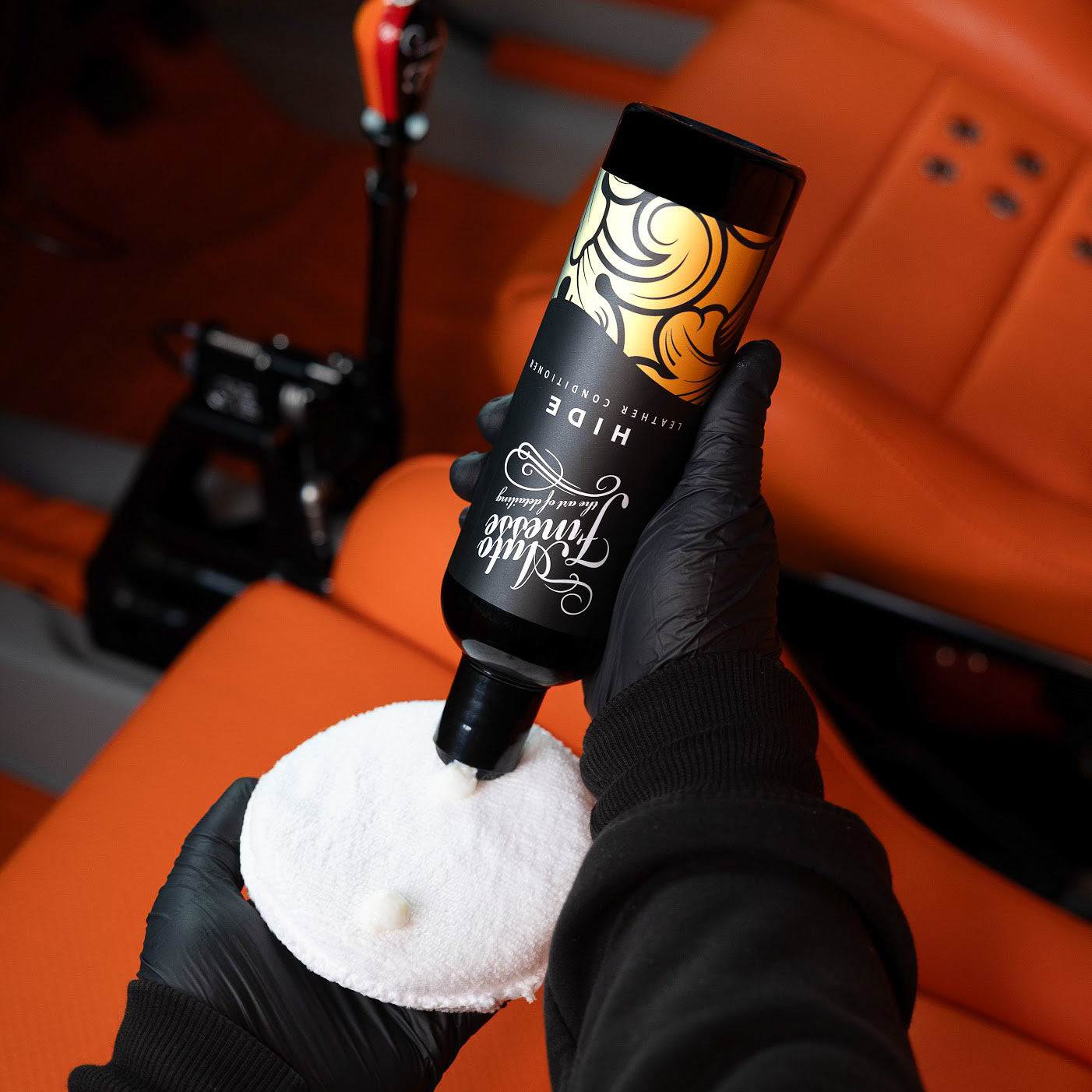 Applying Auto Finesse Hide leather conditioner to a seat_ Leather Cleaning Kit