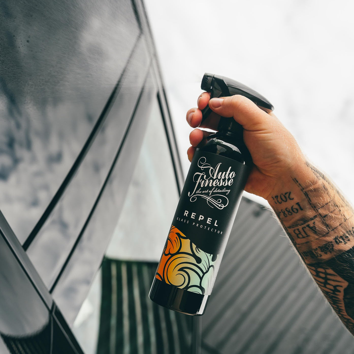 Spraying Auto Finesse Repel glass protector on car window_ The Signature Selection