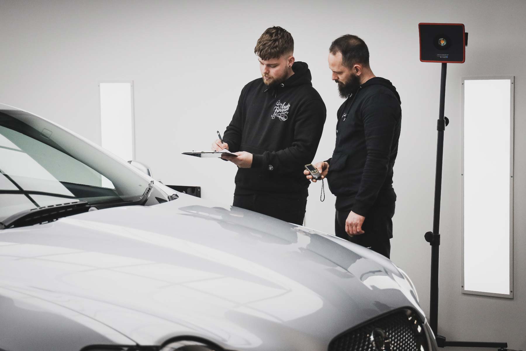 Two detailers checking their work
