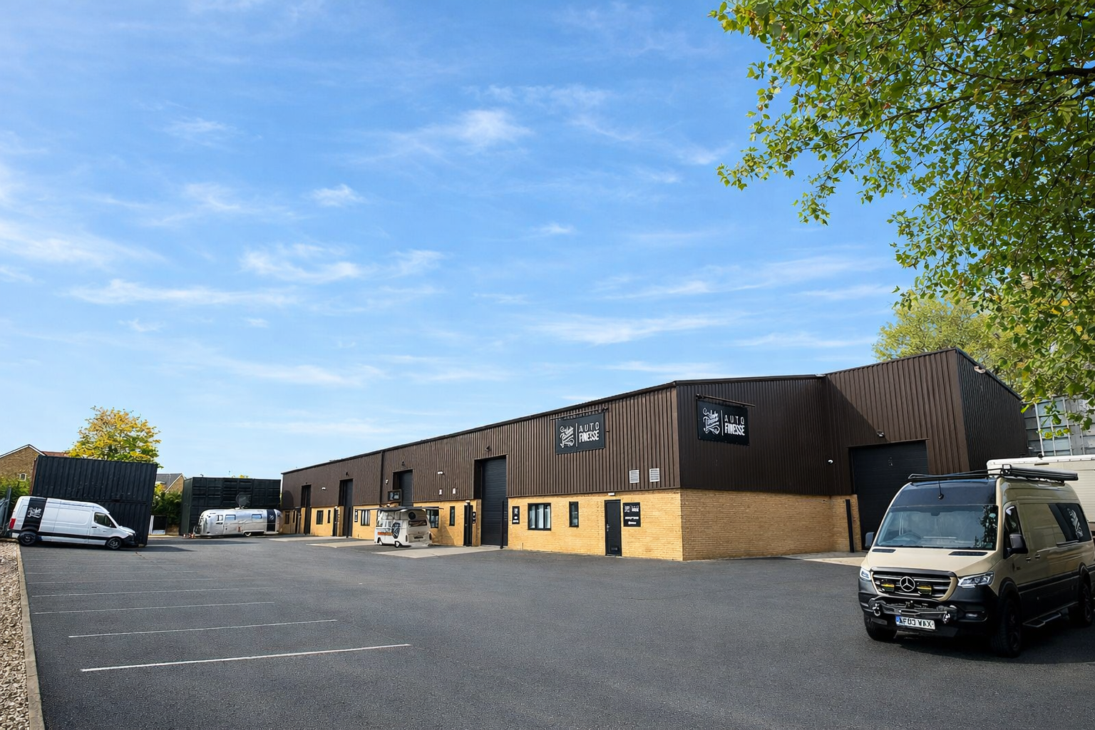 Exterior view of Auto Finesse building with vans