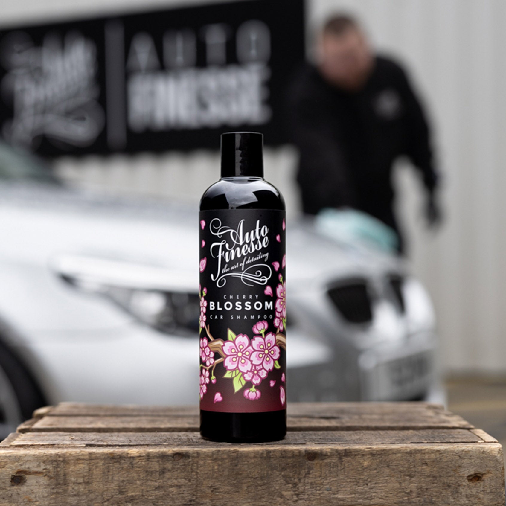 Cherry Blossom Car Shampoo placed on a wooden table