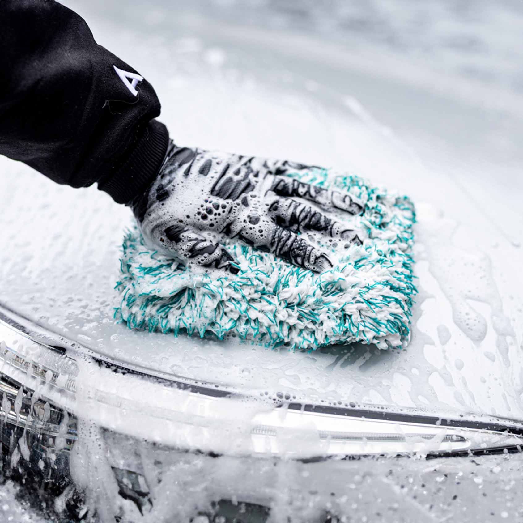 Man washing car with Cherry Blossom Car Shampoo and wash mitt
