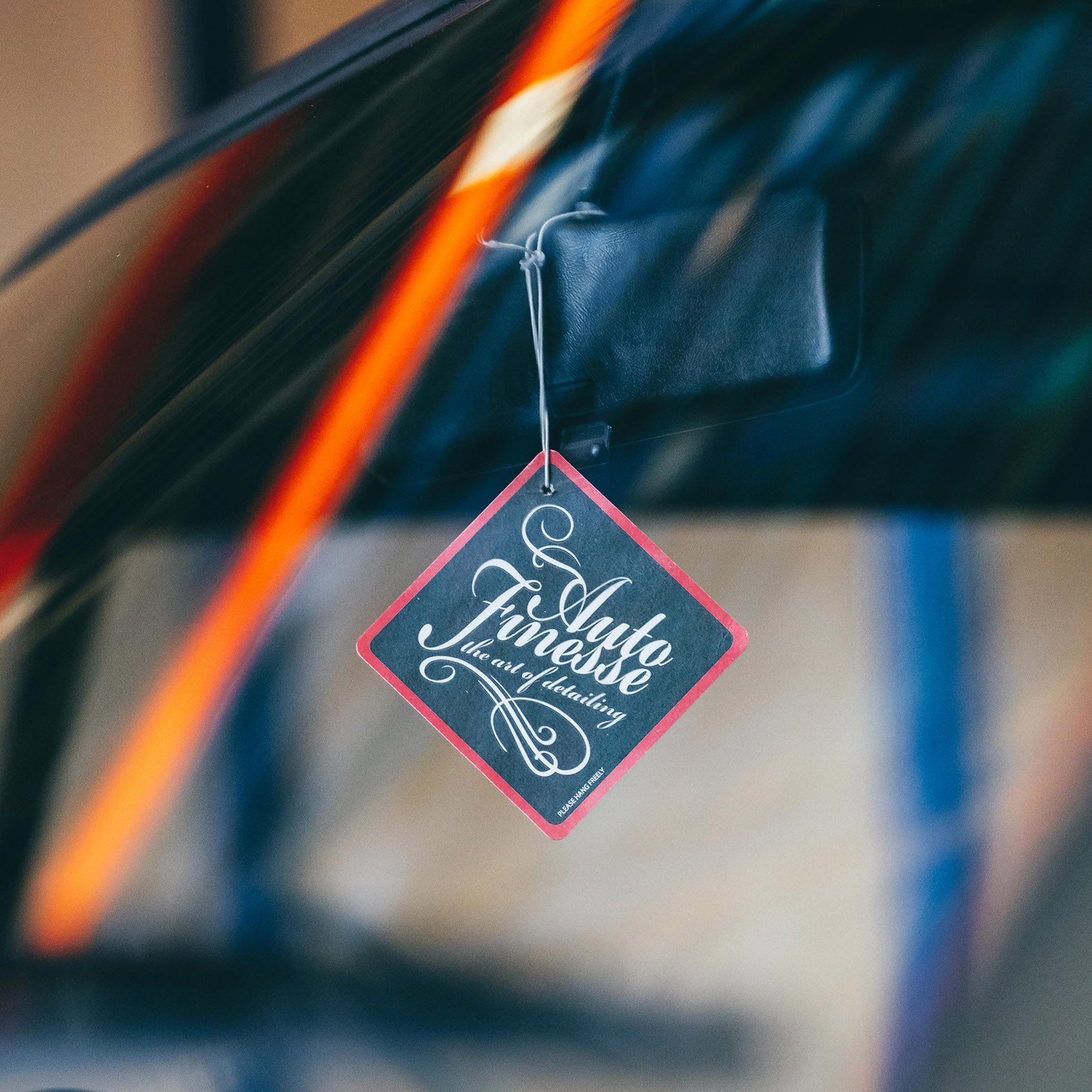 Red Sweet Shop Air Freshener is hanging from rear view mirror
